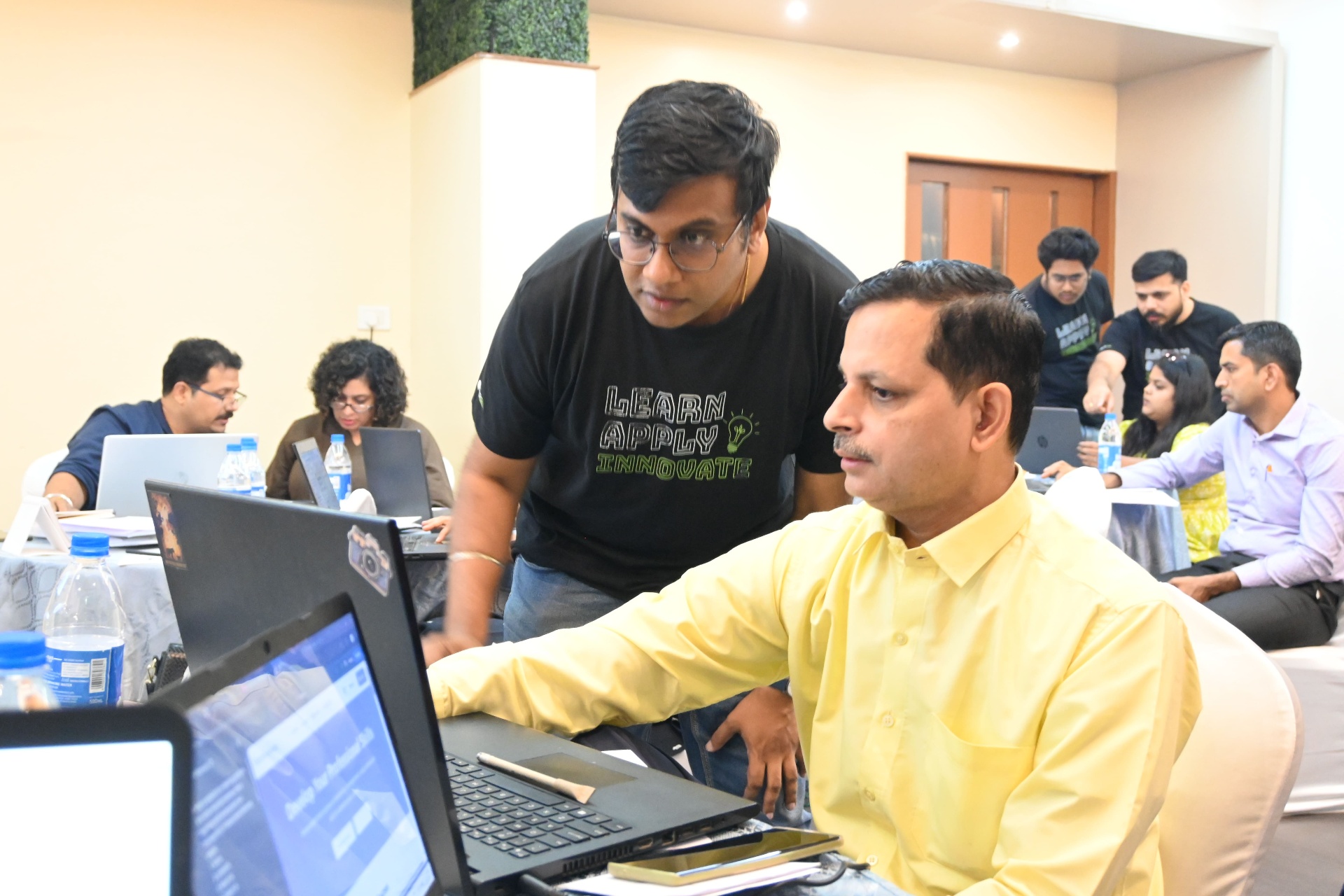 Instructor helping participant with laptop work