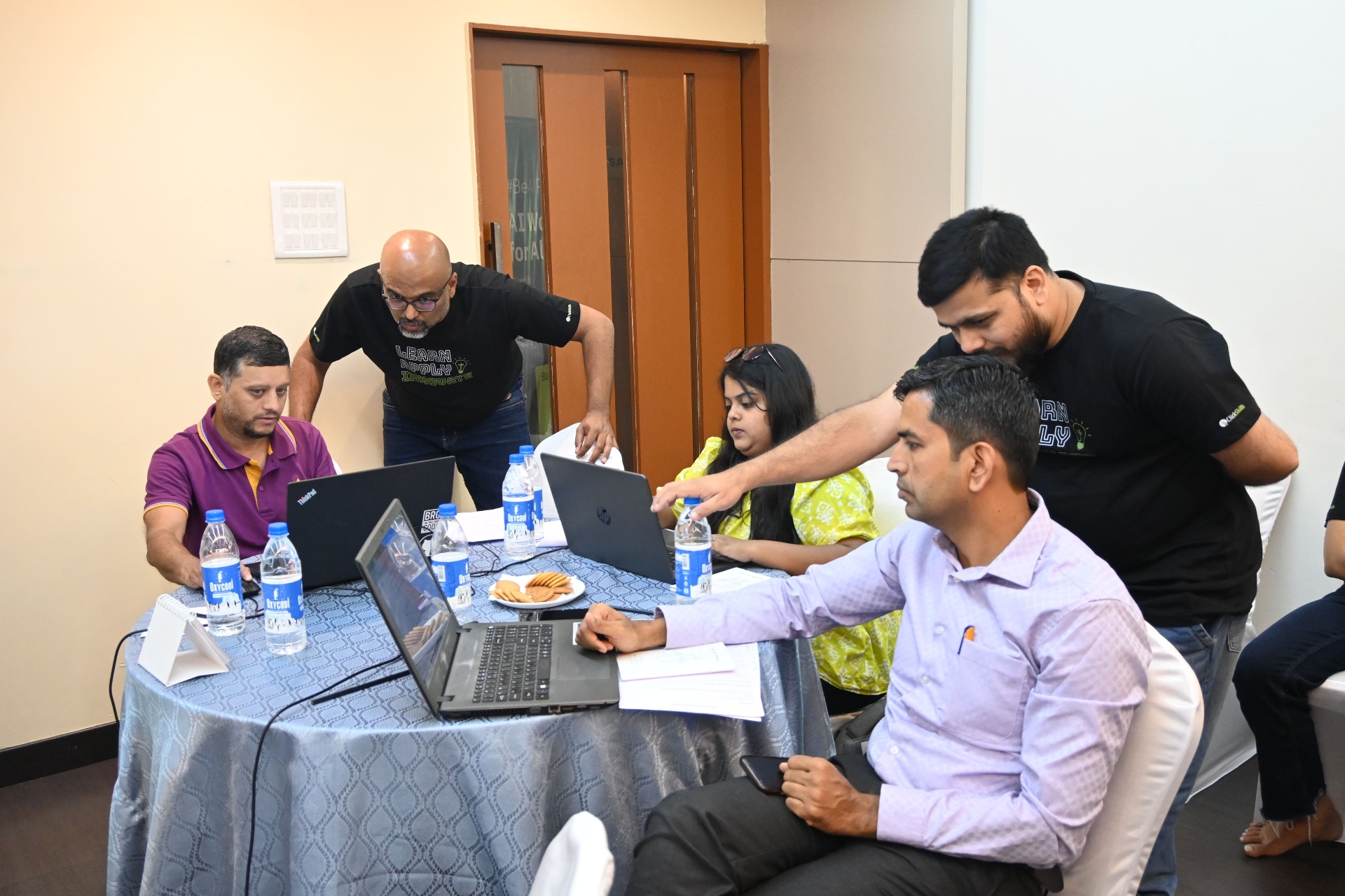 Workshop participants collaborating around laptops